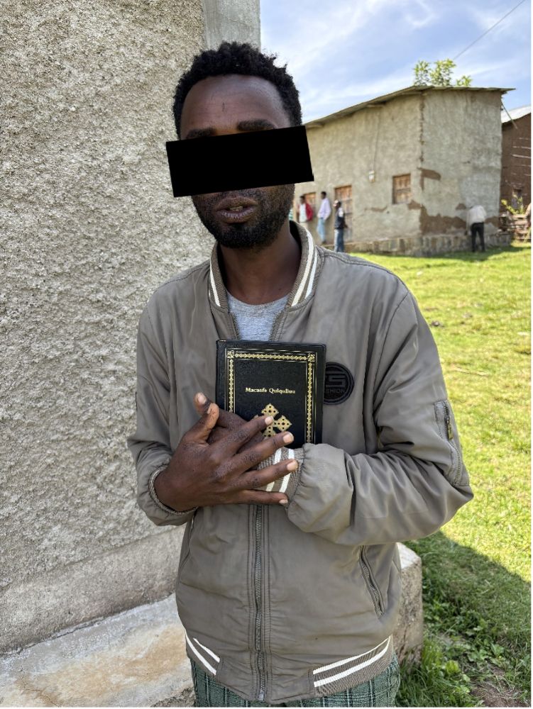 Muse holding his new Bible.